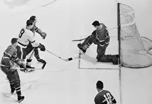 Prints of (Original Caption). Montreal Goalie Jacques Plante kicks out shot by Detroit's Godie Howe (9) as Canadian's beat Red Wings 3-1, capture the Stanley Cup and World Pro Hockey Championship Frozen Moments: A Journey Through Hockey History: Canadians Beating the Red Wings