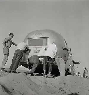 Dessert Prints: Caravan members pushing trailer, Cairo, Egypt. February 08, 1960