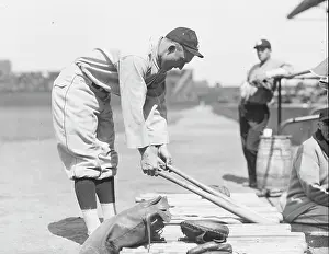 Prints of Hall of Fame player and baseball legend Ty Cobb (1886 - 1961), of the American League's Detroit Tigers, leans over and picks up a baseball bat from a row of bats MLB Legends Art Prints: Top 10 Greatest Baseball Players of All Time: A Careful Decision