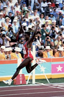 Prints of (Original Caption). USA: Carl Lewis wins 100m gold in 9.9 seconds following Louis is Ray Stewart A Legacy of Speed and Grace: Carl Lewis Finishing Track Event for an Olympic Gold Medal