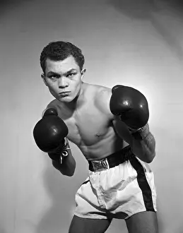Prints of BRONX, NY - JANUARY 14: Lightweight professional boxer Carlos Ortiz of Puerto Rico poses for a portrait on January 14, 1957 in the Bronx, New York In the Ring: The Art of Boxing: Carlos Ortiz