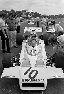 Prints of Argentine Formula One driver Carlos Lole Reutemann (1942 - 2021) sits in his car, as crew members stand around him, at the Argentine Grand Prix, Buenos Aires, Argentina, January 28, 1973 Legends of the Track: Carlos Reutemann At The Argentine Grand Prix