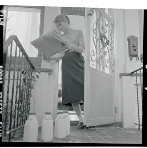 Carol Heiss Reading Newspaper and Standing in Her Doorway