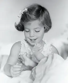 Caroline Kennedy Playing with Toes of Newborn JFK Jr