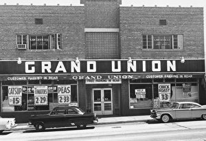 Shop Gallery: Cars parked on town street, in front of shop, (B&W)
