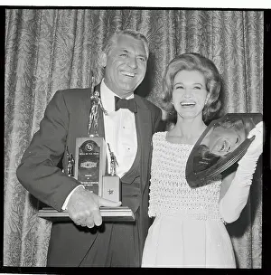 Cary Grant and Angie Dickinson Holding Awards