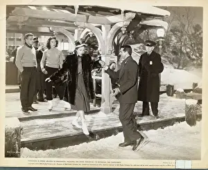 Cary Grant Helping Loretta Young onto Ice Rink