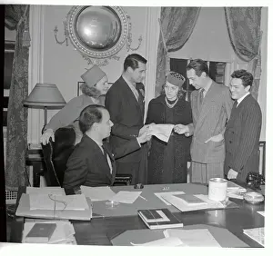 Prints of (Original Caption) A Glamorous Journey Through Time: Cary Grant and Other Stars Receiving Christmas Tree Permit