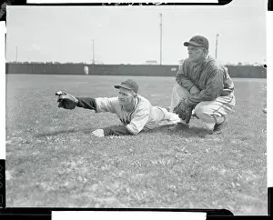 Casey Stengel and Dan Taylor Conversing While Lying on Field
