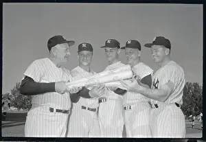 Casey Stengel Handing Bats to New Players