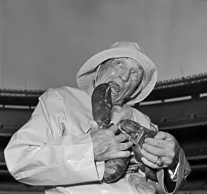Casey Stengel Sitting on Bench and Eating