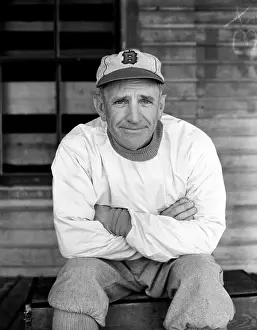 Casey Stengel Wearing Baseball Cap and Sitting With Arms Crossed