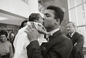 Cassius Clay Kissing Very Small Baby