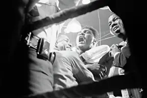 Cassius Clay Sitting in Ring and Cheering for His Victory