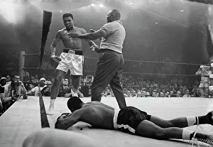Lewiston Prints: Cassius Clay Towering Over Sonny Liston During Boxing Match