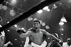 Prints of (Original Caption) I'm the champ! screams Cassius Clay as his handlers hug him joyfully after he defeated Sonny Liston for the heavyweight boxing title A photo tribute to the boxing legend: Cassius Clay After Winning Championship