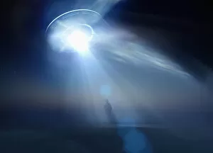 Images Dated 7th September 2016: Caucasian man standing in beam of light from UFO