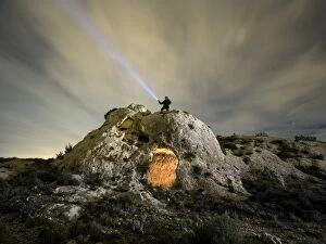 Images Dated 8th January 2016: Cave excavated on the rock with a man on top, making signals with a flashlight