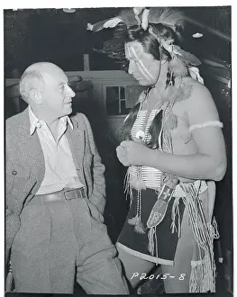 Cecil B Prints: Cecil B. DeMille With Monte Blue in Native Costume