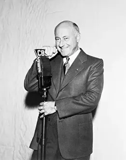Cecil B Prints: Cecil B. DeMille Standing at Microphone