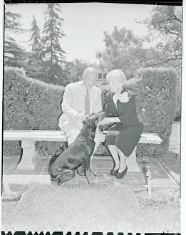 Cecil B. DeMille and Wife Sitting Outside With Dog