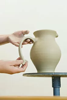 Ceramic artist working in her workshop, pulling a handle for a pitcher, Geisenhausen, Bavaria, Germany, Europe