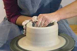 Images Dated 18th December 2009: Ceramic artist working in her workshop with a potters wheel, pulling a cylinder, Geisenhausen