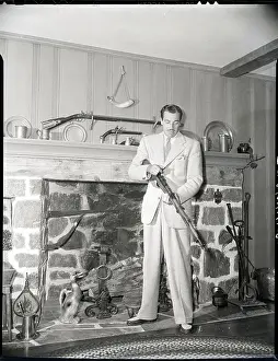 Collection Prints: Cesar Romero Checking Gun In Living Room