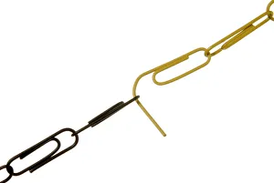 Chain of black and yellow paper clips dissolving where they are joined Chain of black and yellow paper clips dissolving where they are joined