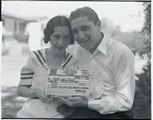 Charles J. Bigelow and Wife Displaying Telegram Cake