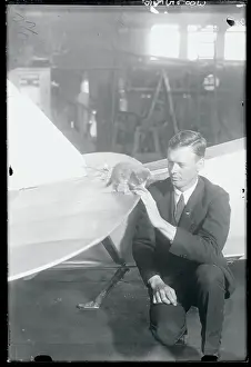 Charles Lindbergh Sitting at Airplane With Kitten Mascot on a Wing
