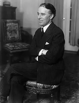 Prints of (Original Caption) Charlie Smiles For The Papers. The famous comedian, Charles Spencer Chaplin, Jr Master of Mime, Icon of Cinema: Chaplin in Prints: Charles S. Chaplin with Folded Arms