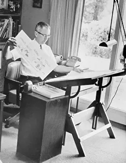 Charles M Prints: Charles Schulz Working on Drawing Board