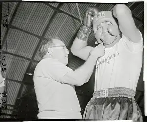 Grossinger Prints: Charley Goldman Helping Rocky Marciano Put on His Headgear