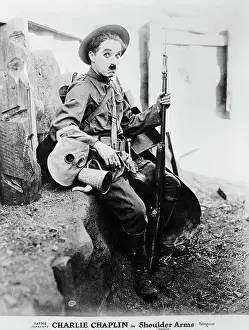 Prints of Charlie Chaplin as the recruit inhis 1918 film Shoulder Arms set in the trenches of WWI At The Movies: Charlie Chaplan