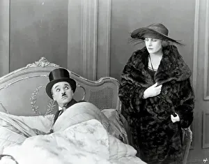 Prints of (Original Caption). Charlie Chaplin and Edna Purviance in bedroom scene. Movie still from The Idle Class, 1921 Master of Mime, Icon of Cinema: Chaplin in Prints: Charlie Chaplin and Edna Purviance in The Idle Class
