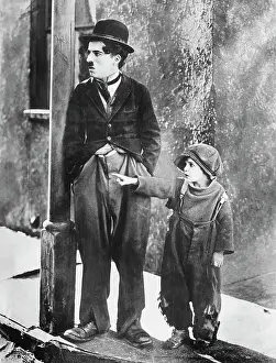 Prints of (Original Caption). Charlie Chaplin and Jackie Coogan in The Kid BPA2# 3197 Master of Mime, Icon of Cinema: Chaplin in Prints: Charlie Chaplin and Jackie Coogan in The Kid