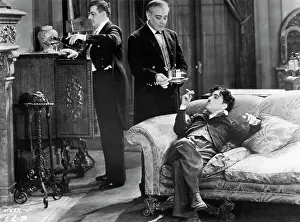 Prints of (Original Caption). Charlie Chaplin reclining luxuriously on a sofa in a scene from City Lights. Movie still, undated Master of Mime, Icon of Cinema: Chaplin in Prints: Charlie Chaplin Reclining On A Sofa