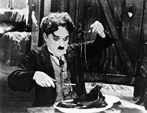 Prints of The Gold Rush (1925) was written and directed by Charles Chaplin Master of Mime, Icon of Cinema: Chaplin in Prints: Charlie Chaplin in the Shoe-Eating Scene from The Gold Rush