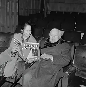 Oona Oneill Prints: Charlie and Oona Chaplin Looking at a Book