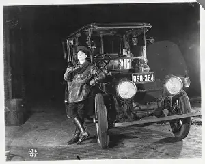 Chauffeur Leaning on Automobile