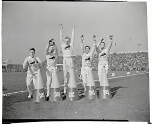 Cheer Leaders Standing Near Horns on Field