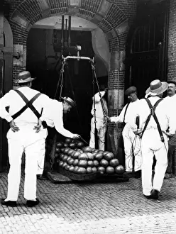 Prints of Traders weighing Dutch cheeses in the cheese market in Alkmaar, Holland. (Photo by F J Mortimer/Getty Images) Francis James Mortimer (1874-1944) Prints: Cheese Weighing