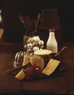 Freshness Collection: Cheese on wooden board with milk and eggs in background