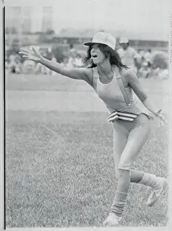 Cher Pitching During Softball Game