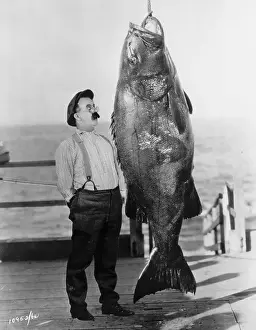 Chester Conklin Stands by Giant Fish
