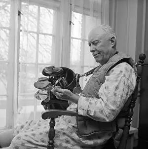 Chick Evans Prints: Chick Evans Looking over Golf Clubs