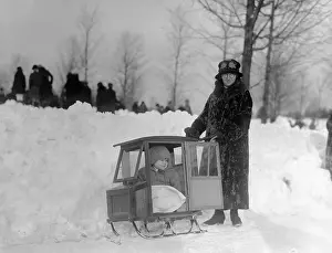 Strange Prints: Child (12-23 months) in baby carriage sledge and mother in fur coat