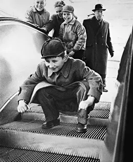 Walkway Prints: Child Crouching on Escalator