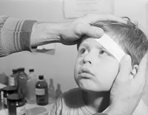 First Aid Prints: Child Getting Forehead Bandaged